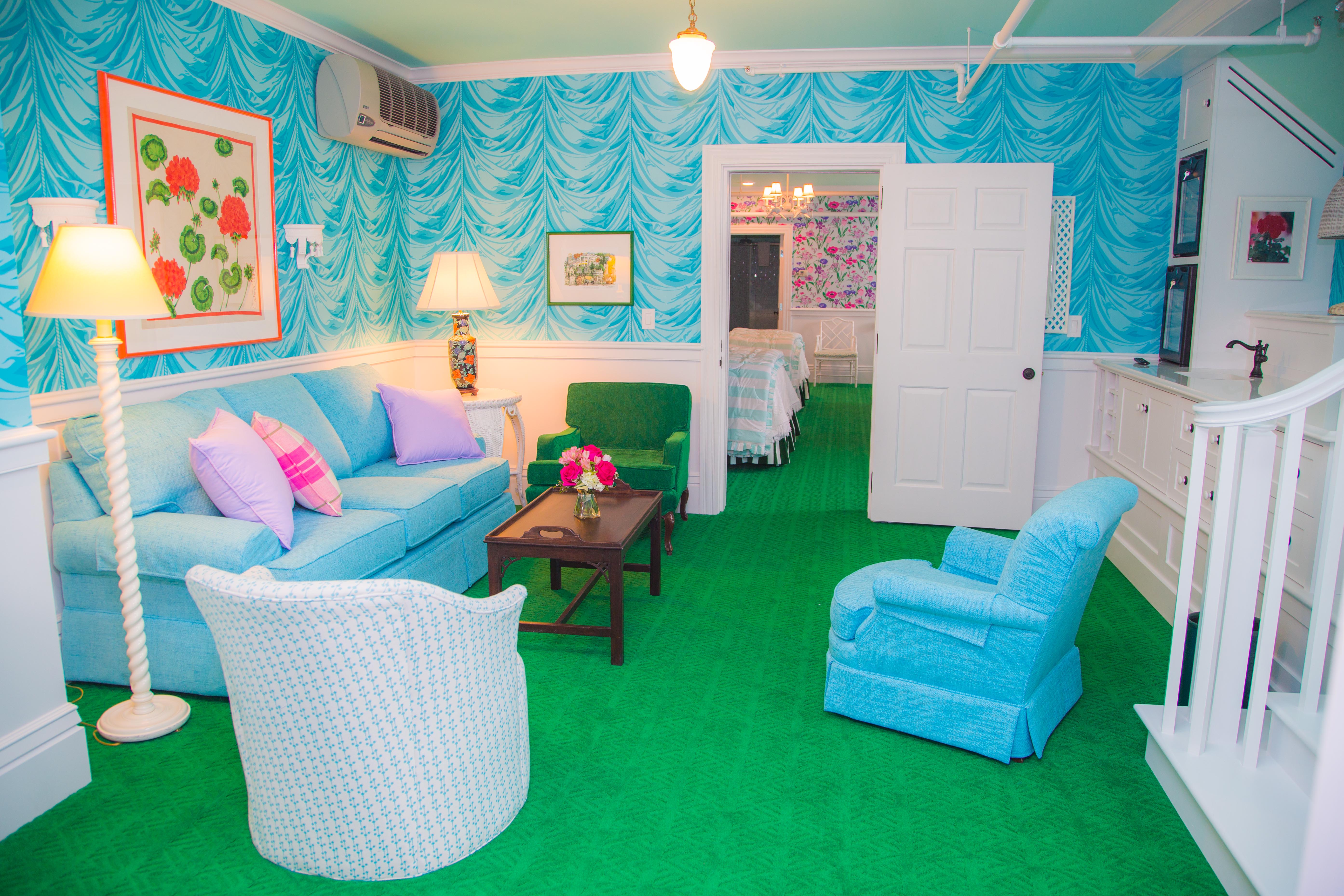 Image of the sitting area with vibrant sky-blue couches and pastel pink and purple pillows. Grand Hotel, a member of Historic Hotels since 2001, dates to 1886. It is located in Mackinac Island, Michigan.
